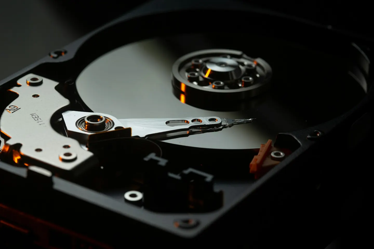 The platter and arm of an open hard drive